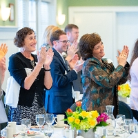 Many alumni clapping for speech